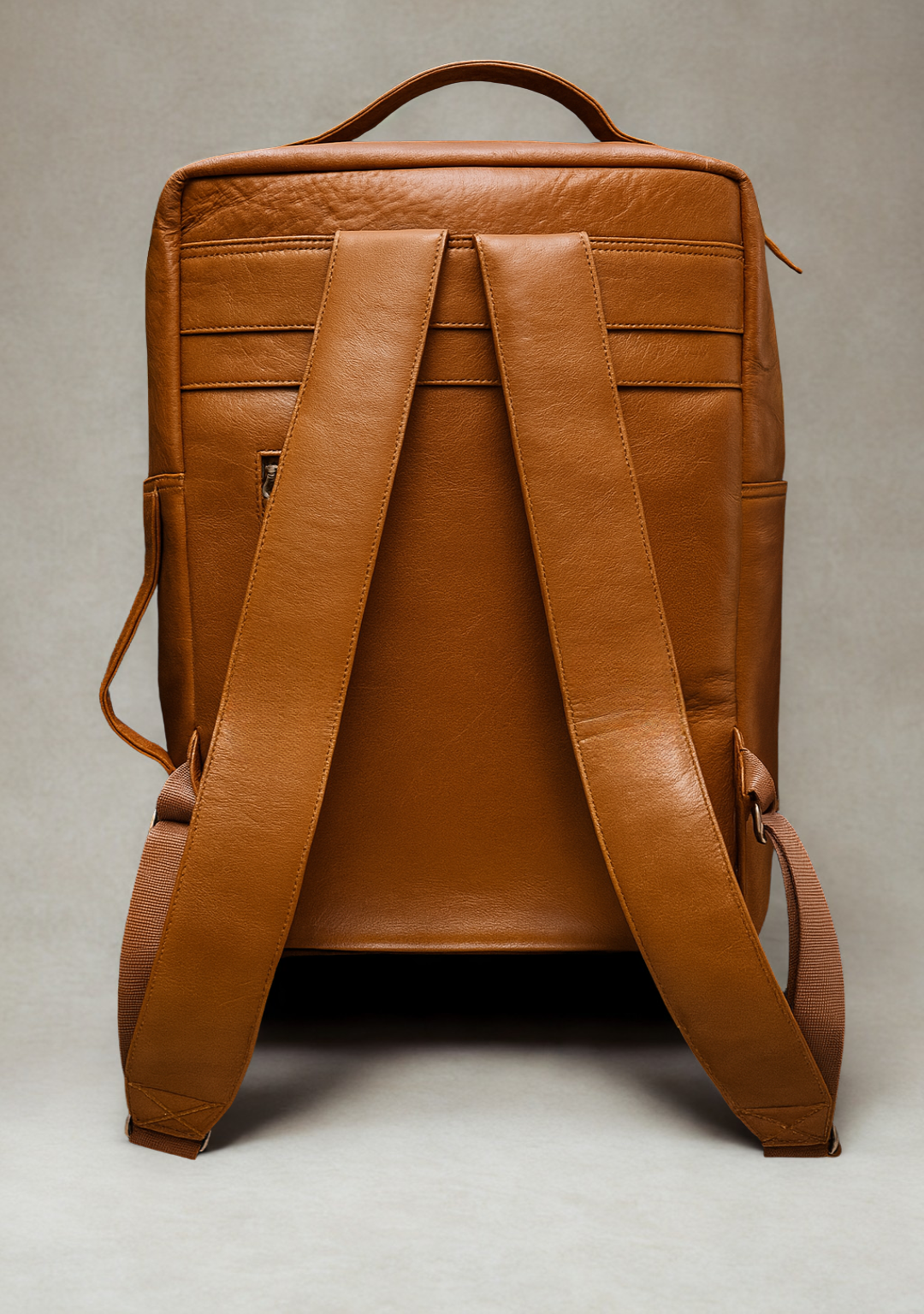 Back of FAMU Brown leather backpack on a light gray background