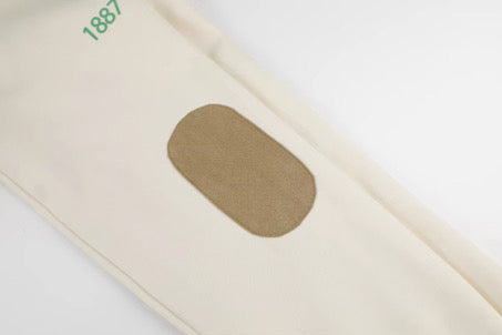 Beige fabric with a brown patch on a white background