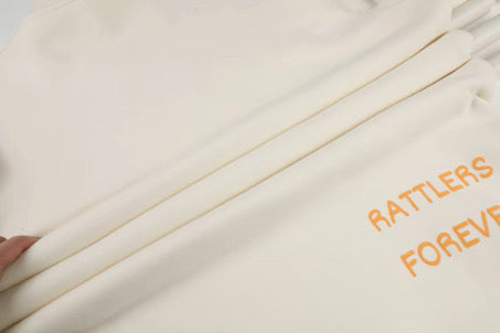 Text 'RATTLERS FOREVER' embroidered on a beige fabric.