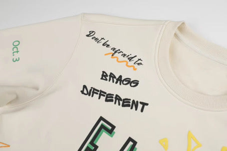 FAMU sweatshirt with text and graphics on a white background