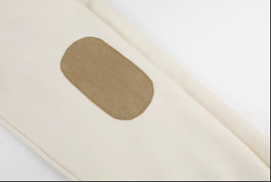 Beige fabric with a brown patch on a white background