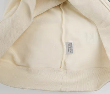 Close-up of a beige fabric with a label on a white background