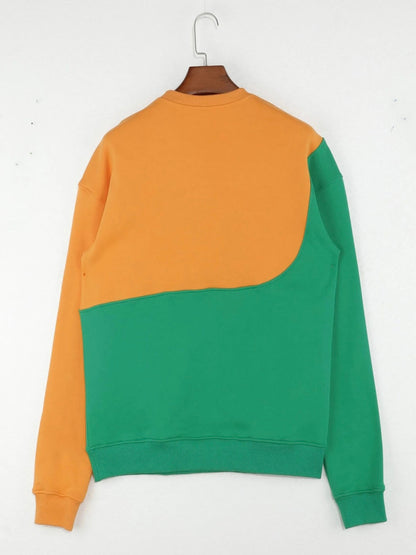Two-tone orange and green sweatshirt on a hanger against a white background
